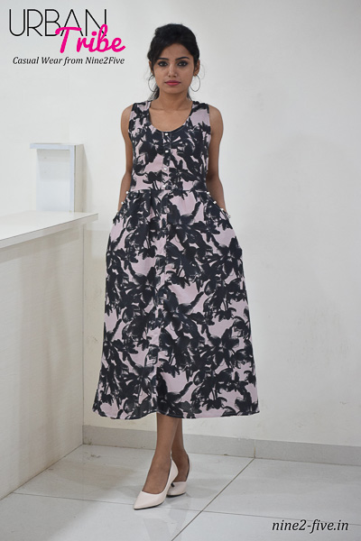 Greyish Pink Printed Polymos Midi dress. Sleeveless. Round Neck. Two Side Pockets With Fancy Buttons. It can be machine washed in cold water. Model of 5 feet 4 inches is wearing S Size