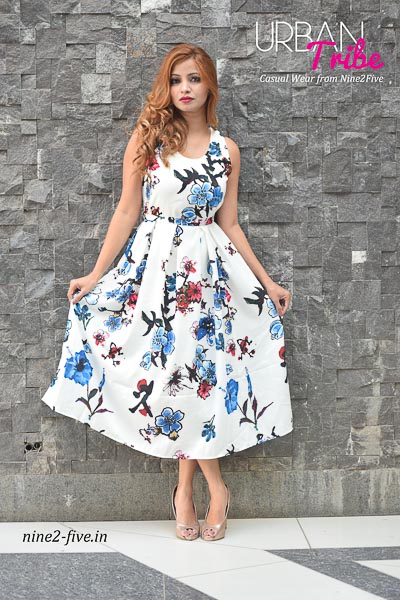 White Floral Print Heavy Polymos Midi Dress. Crepe Lining. Box Pleats. Sleeveless. Round Neck. It can be machine washed in cold water. Model of 5 feet 4 inches is wearing S Size