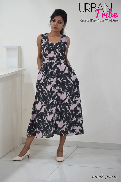 Greyish Pink Printed Polymos Midi dress. Sleeveless. Round Neck. Two Side Pockets With Fancy Buttons. It can be machine washed in cold water. Model of 5 feet 4 inches is wearing S Size